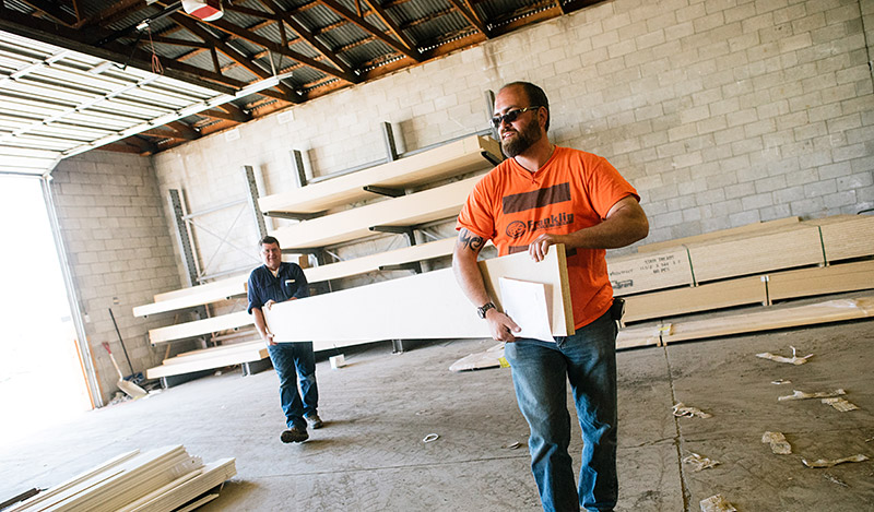 to men carrying boards