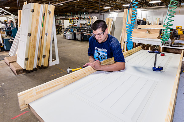 man building a door